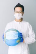 Travel First Aid Kits: Essential Items Every Traveler Needs 40 Conceptual image of a doctor holding a globe with a mask, symbolizing global health. travel first aid kit