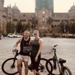 Mumbai in Contrast Part 2: Bollywood Dreams, Slum Reality, Bike Rides, and Street Food 31 Couple with bikes in front of Victoria train station Mumbai