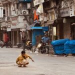 Mumbai in Contrast Part 2: Bollywood Dreams, Slum Reality, Bike Rides, and Street Food 32 man squatting looking for gold, Mumbai