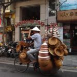 man riding a bike with cone hats, Hanoi